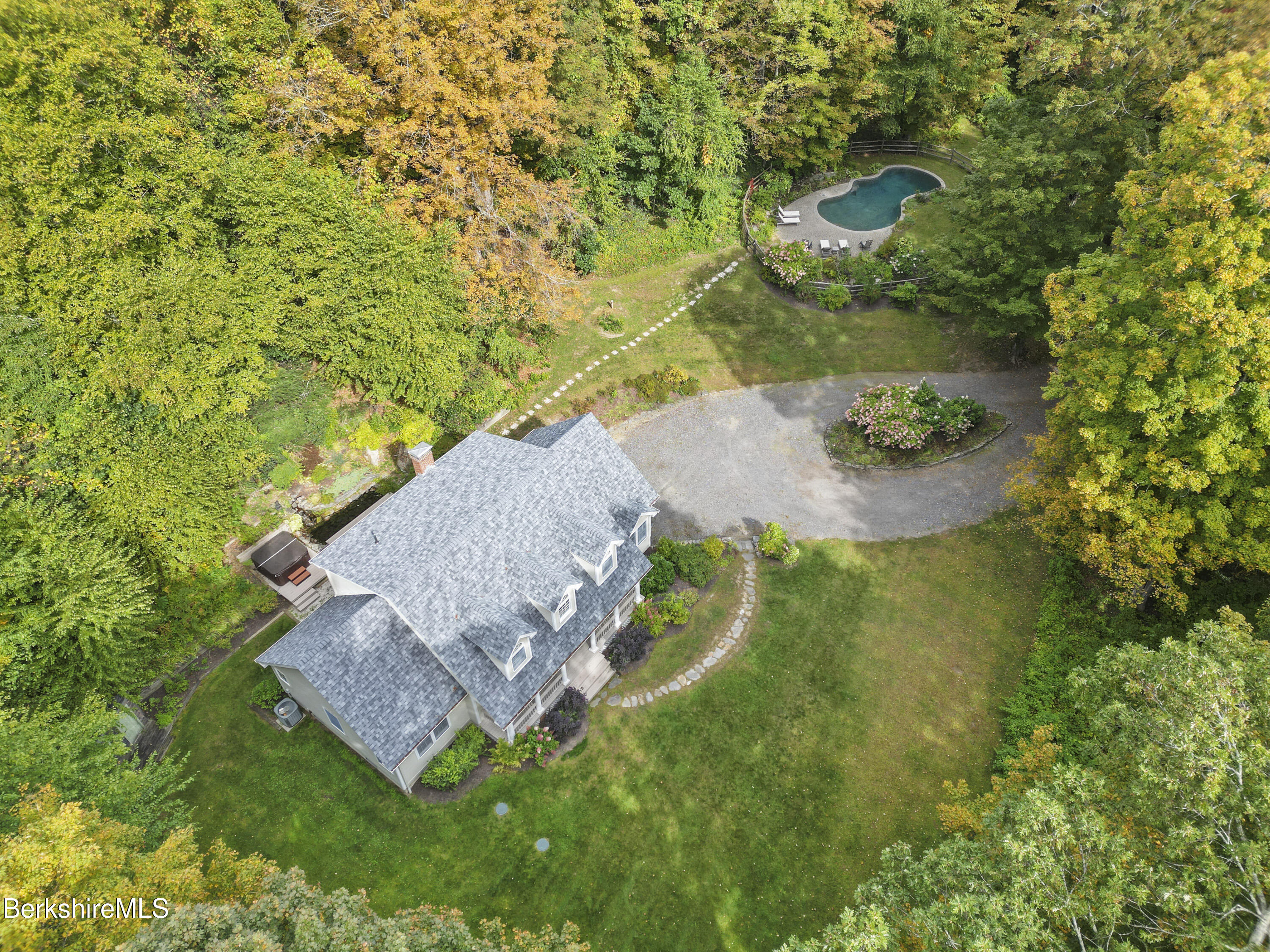 an aerial view of a house with a yard