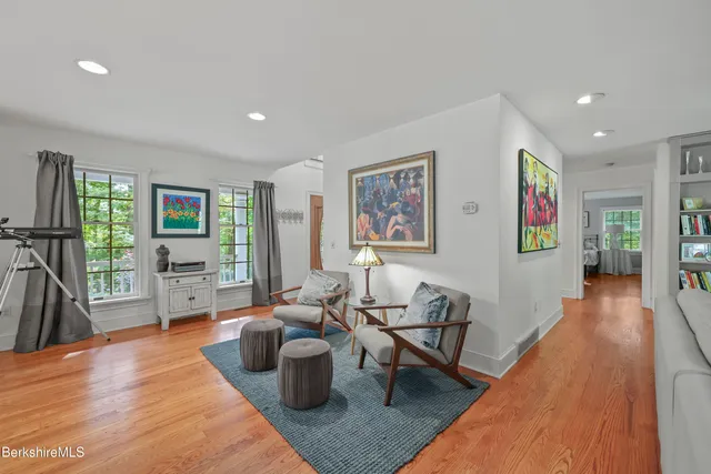 a living room with fireplace furniture and a wooden floor