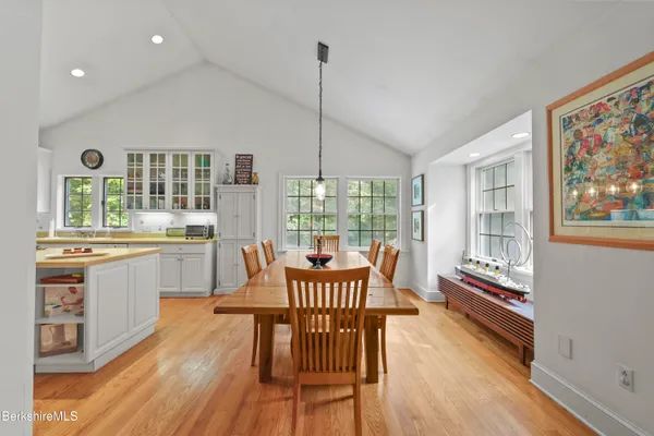 a dining room with furniture a chandelier and wooden floor