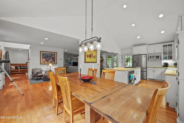 a view of a dining room with furniture and a chandelier