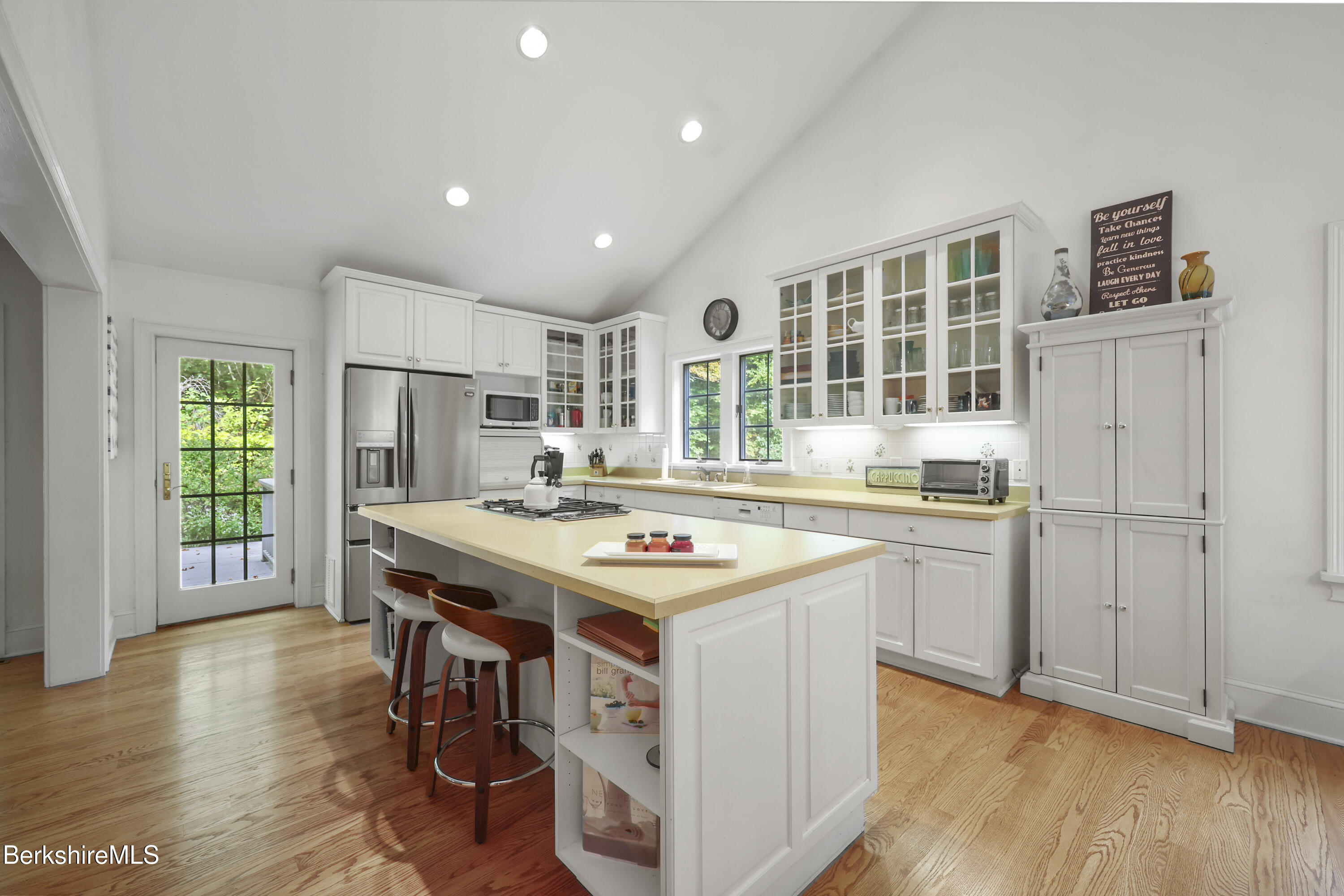 905 W Road Sheffield, MA 01230 - Photo 19 of 60 a kitchen with stainless steel appliances granite countertop a stove a refrigerator a sink dishwasher and a dining table with wooden floor