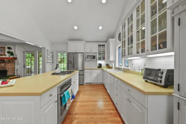 a kitchen with stainless steel appliances a stove a sink and a refrigerator