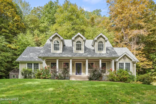 a front view of a house with a yard and porch