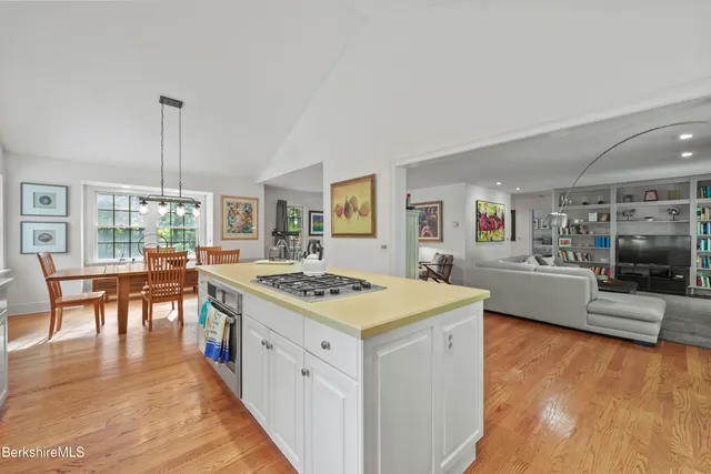 a bedroom with a bed and a dresser next to a window