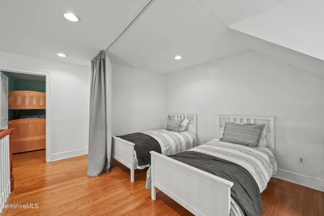 a bedroom with a bed and a mirror