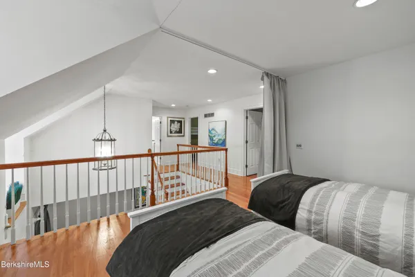 a hallway with windows and chandelier
