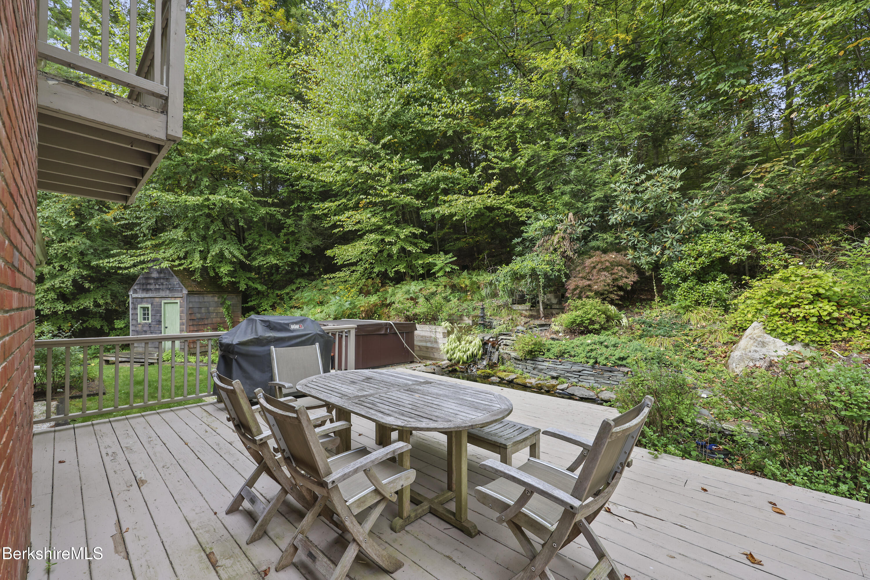905 W Road Sheffield, MA 01230 - Photo 46 of 60 a view of a backyard with table and chairs and wooden floor