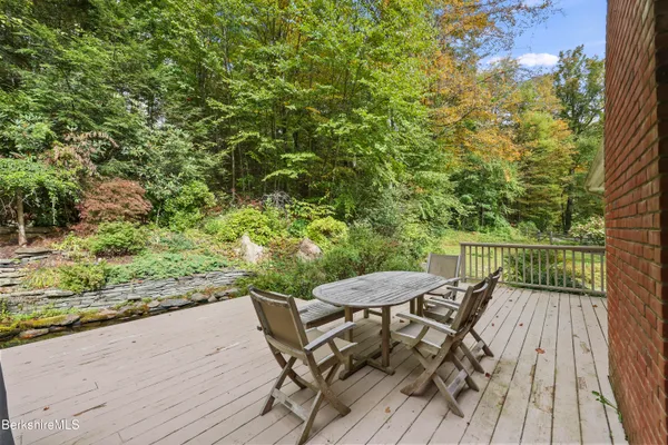a aerial view of a house with a yard plants and large tree