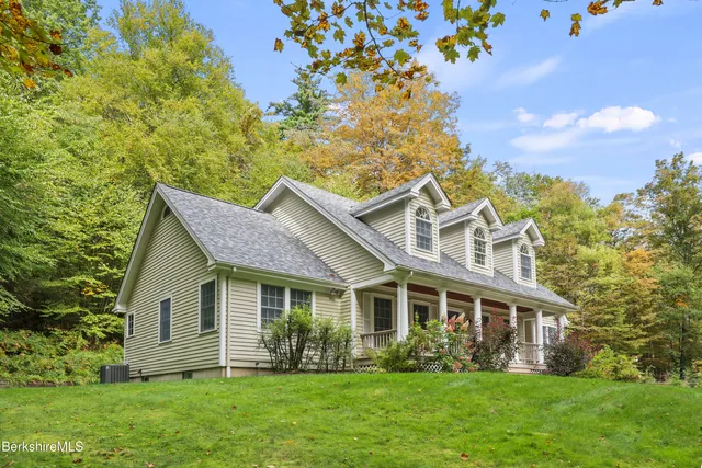 a front view of house with yard and green space