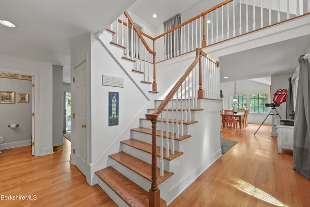 a view of entryway and hall with wooden floor