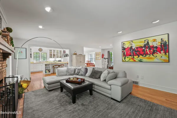 a living room with furniture a rug and a large window