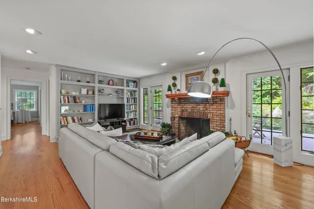 a living room with furniture a fireplace and a flat screen tv