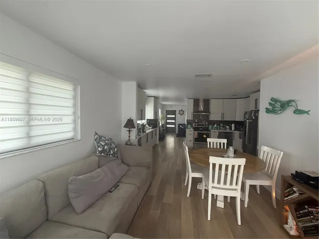 a dining room with furniture and wooden floor