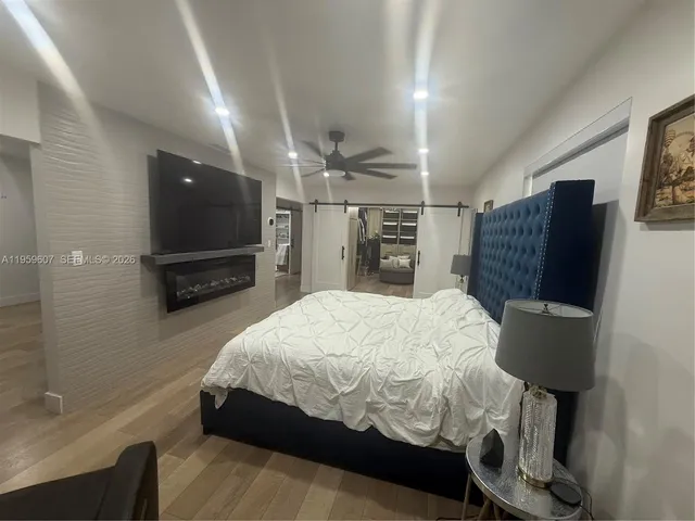 a bed sitting in a bedroom and tv