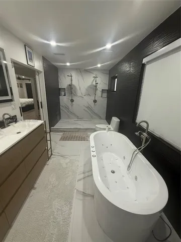 a bathroom with a sink a toilet and mirror