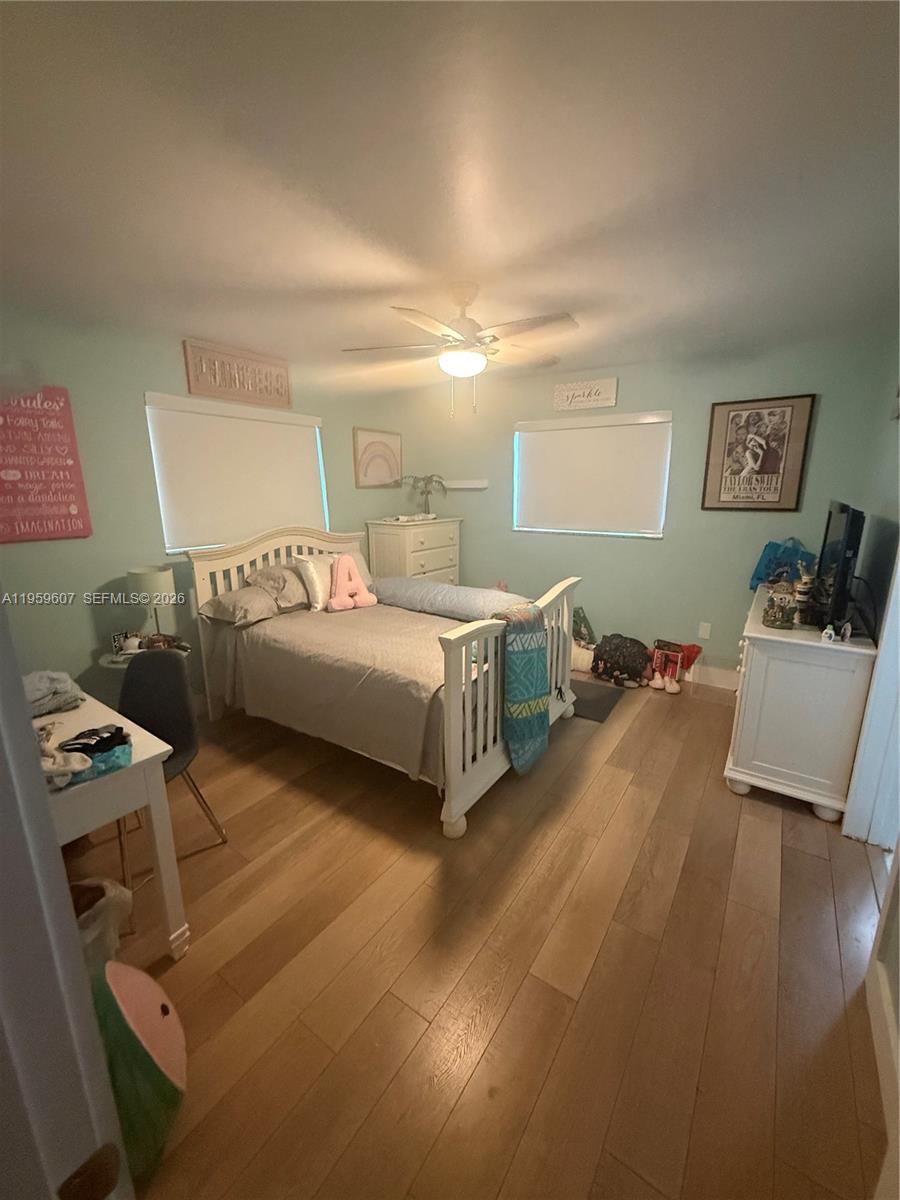 3050 Southwest 26th Street Miami, FL 33133 - Photo 6 of 11 a bedroom with a bed and wooden floor