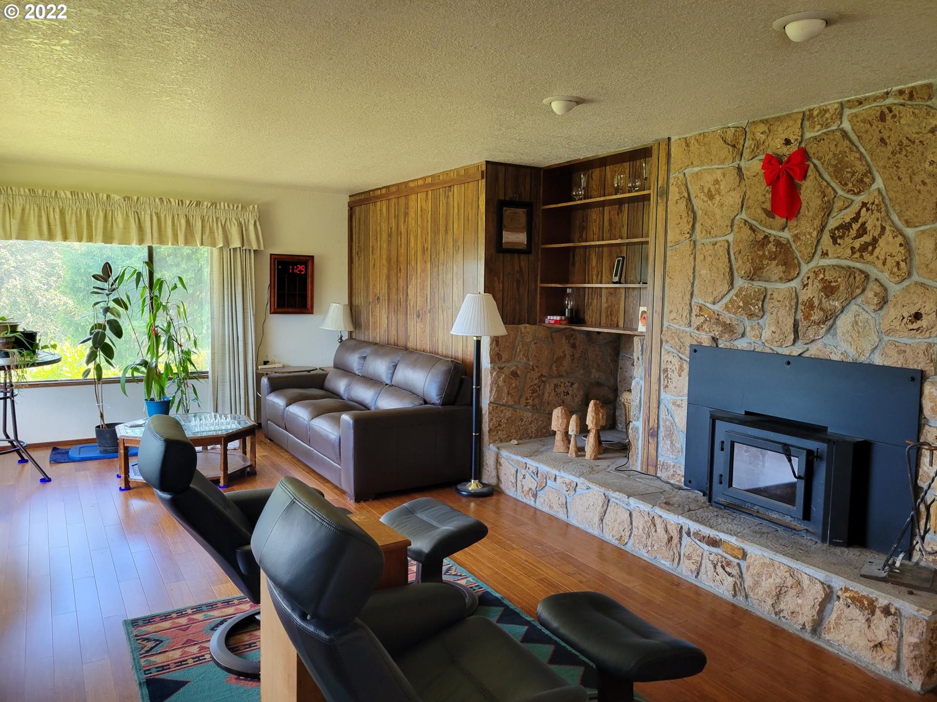 752 Cooper Creek Road Sutherlin, OR 97479 - Photo 8 of 10 a living room with furniture a flat screen tv and a floor to ceiling window