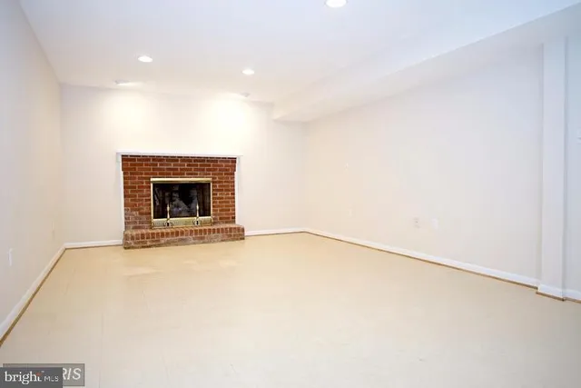 a view of an empty room with a fireplace