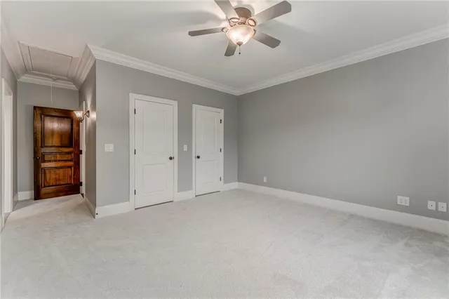 a view of a room with wooden floor chandelier and windows