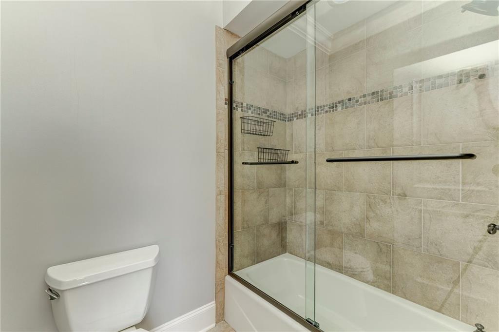 311 Langston Road Southeast Calhoun, GA 30701 - Photo 35 of 100 a bathroom with a shower a toilet and sink