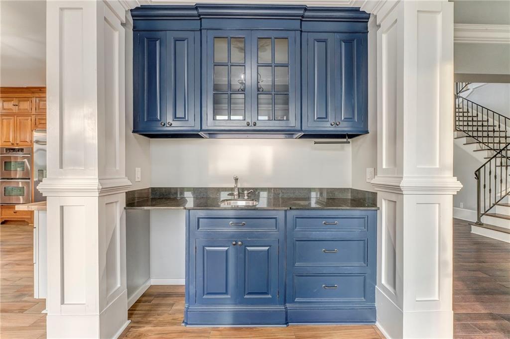 311 Langston Road Southeast Calhoun, GA 30701 - Photo 65 of 100 a kitchen with granite countertop wooden cabinets and a wooden floor