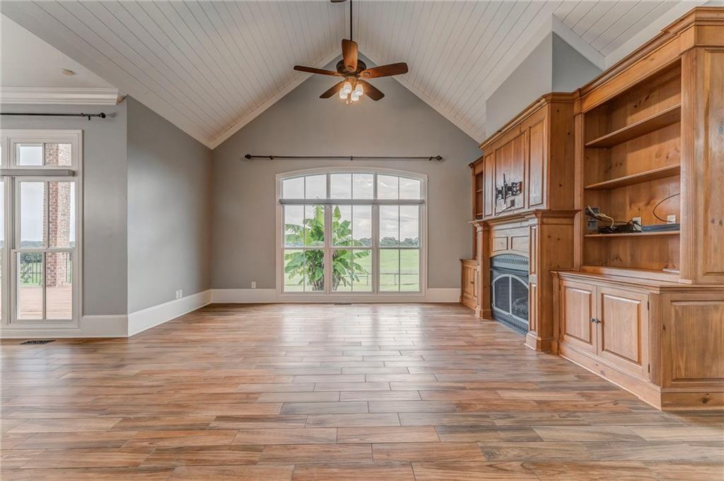 311 Langston Road Southeast Calhoun, GA 30701 - Photo 72 of 100 a view of an empty room with a window and wooden floor