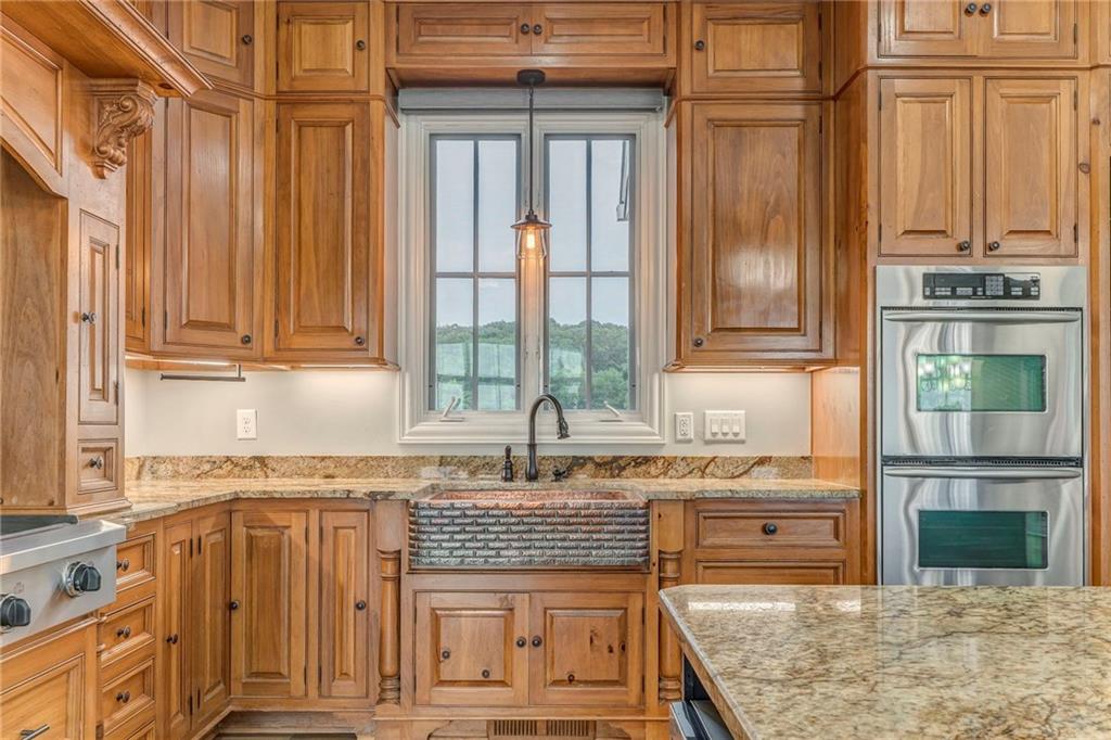 311 Langston Road Southeast Calhoun, GA 30701 - Photo 77 of 100 a kitchen with stainless steel appliances granite countertop a stove a sink and a microwave
