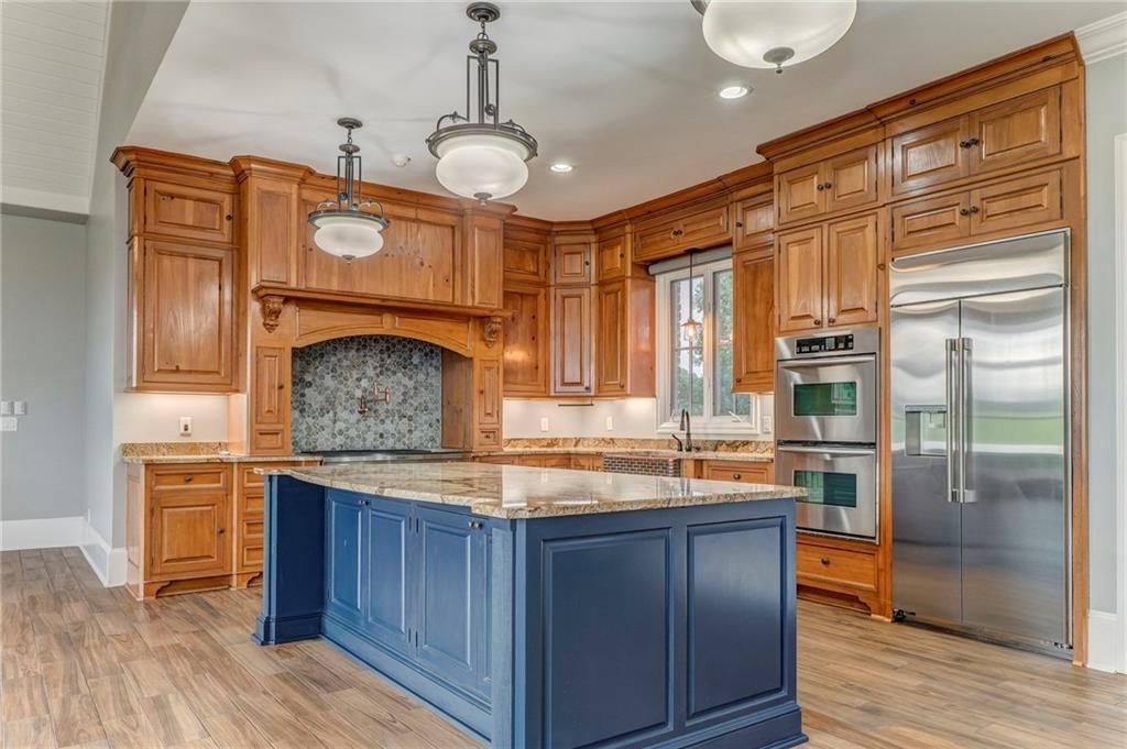 311 Langston Road Southeast Calhoun, GA 30701 - Photo 78 of 100 a kitchen with granite countertop wooden cabinets and stainless steel appliances