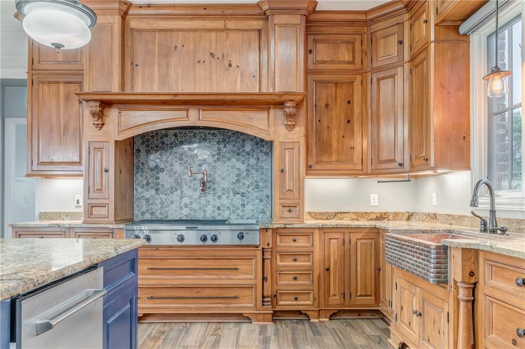 311 Langston Road Southeast Calhoun, GA 30701 - Photo 79 of 100 a kitchen with granite countertop a sink and a stove next to a window