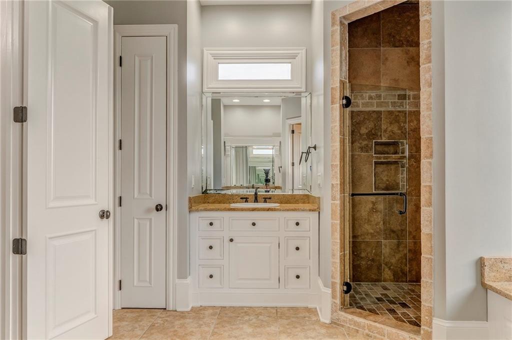 311 Langston Road Southeast Calhoun, GA 30701 - Photo 90 of 100 a bathroom with a granite countertop sink a mirror and a shower