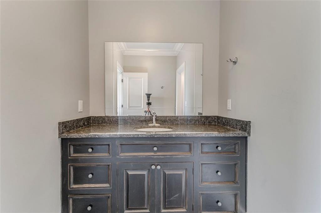 311 Langston Road Southeast Calhoun, GA 30701 - Photo 10 of 100 a bathroom with a granite countertop sink a mirror and a