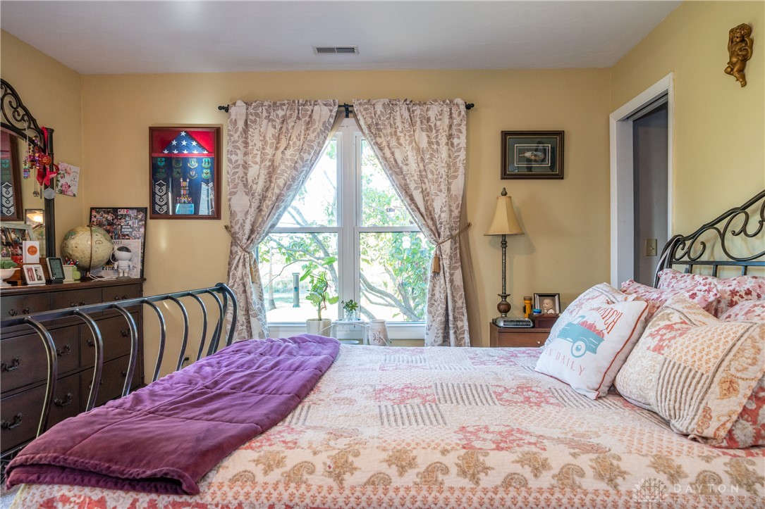 1599 Garringer Road Jamestown, OH 45335 - Photo 16 of 73 A bright bedroom with ample natural light offers a peaceful retreat.