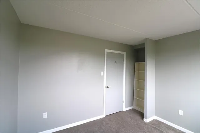 an empty room with closet area