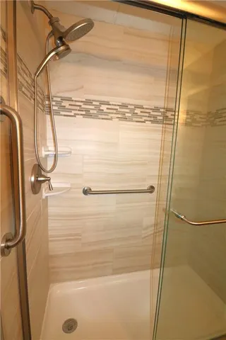 a bathroom with a glass shower door