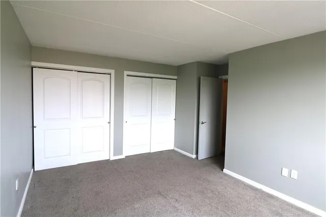 a view of an empty room and closet area