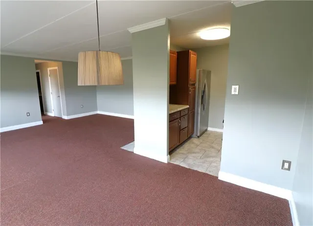 a view of a kitchen with a sink and a refrigerator