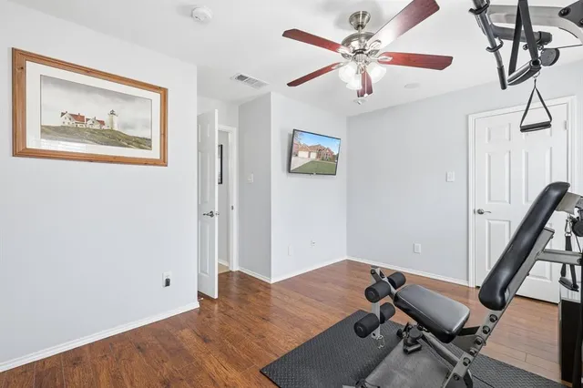 a view of a workspace with furniture and a ceiling fan