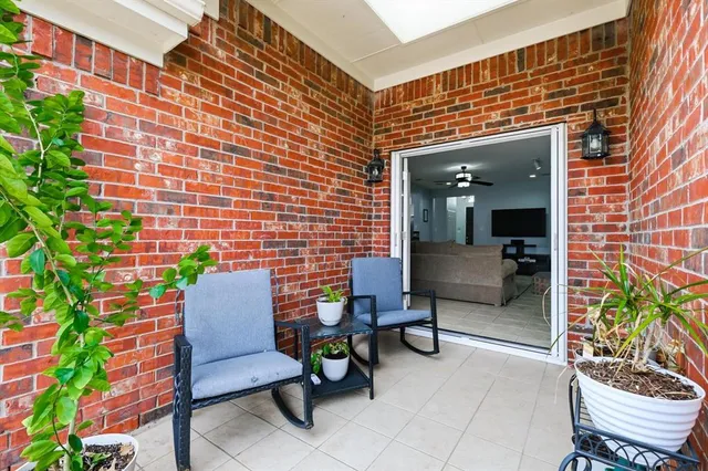 a balcony with furniture and a potted plant