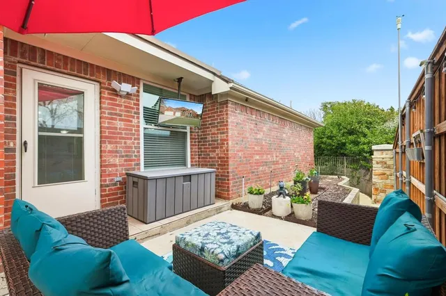a view of a patio with couches table and chairs and potted plants
