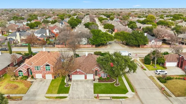 an aerial view of residential houses with outdoor space and swimming pool