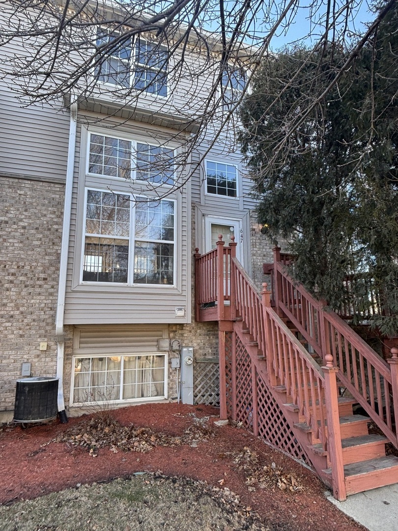 647 Georgian Court, Unit 647 Addison, IL 60101 - Photo 1 of 12 a front view of a house with balcony