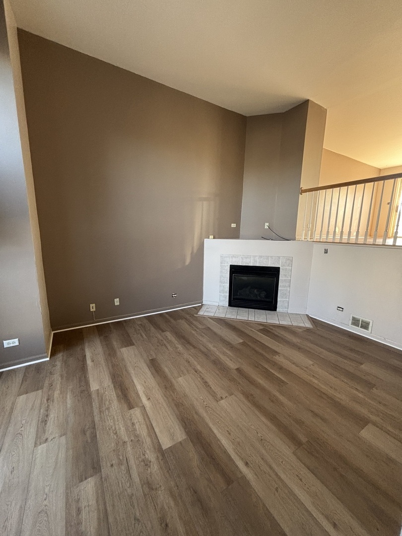 647 Georgian Court, Unit 647 Addison, IL 60101 - Photo 6 of 12 a view of empty room with a fireplace