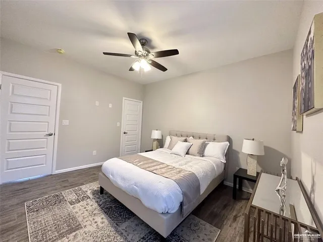 a bedroom with a bed rug and dresser