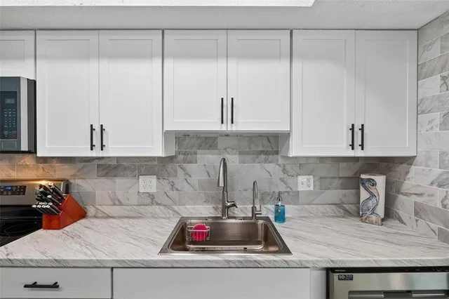 a dining room with furniture a chandelier and wooden floor
