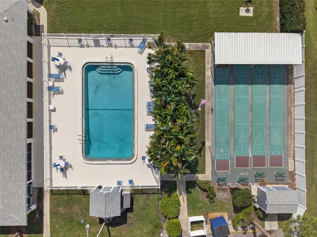 a kitchen that has a lot of white cabinets and stainless steel appliances