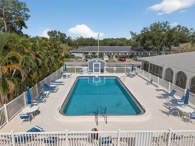 a living room with furniture a rug and white walls
