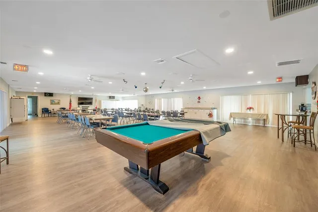 an aerial view of residential houses with outdoor space and ocean view