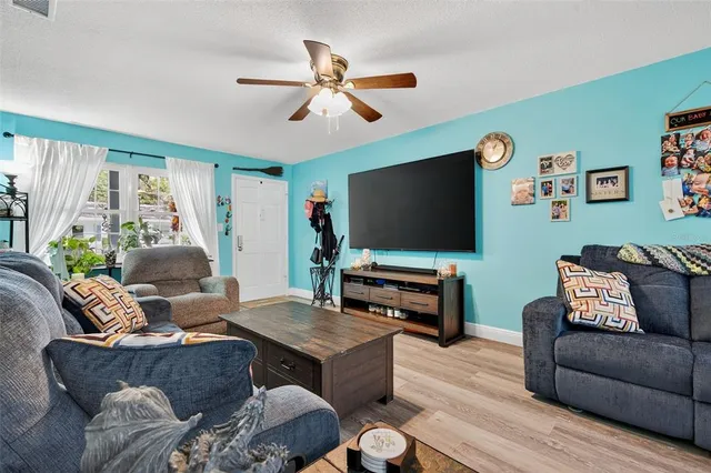 a living room with furniture and wooden floor