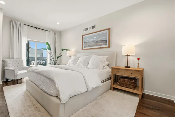 a spacious bedroom with a bed and a large window
