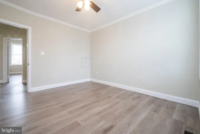 a view of an empty room with wooden floor